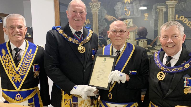 Gerald receives his 60-year certificate from Lincolnshire PGM Dave Wheeler, watched by Provincial DC Noel Fisher, left, and APGM Bruce Goodman.